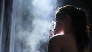 Topless Brunette Smoking in Dramatic Smoke